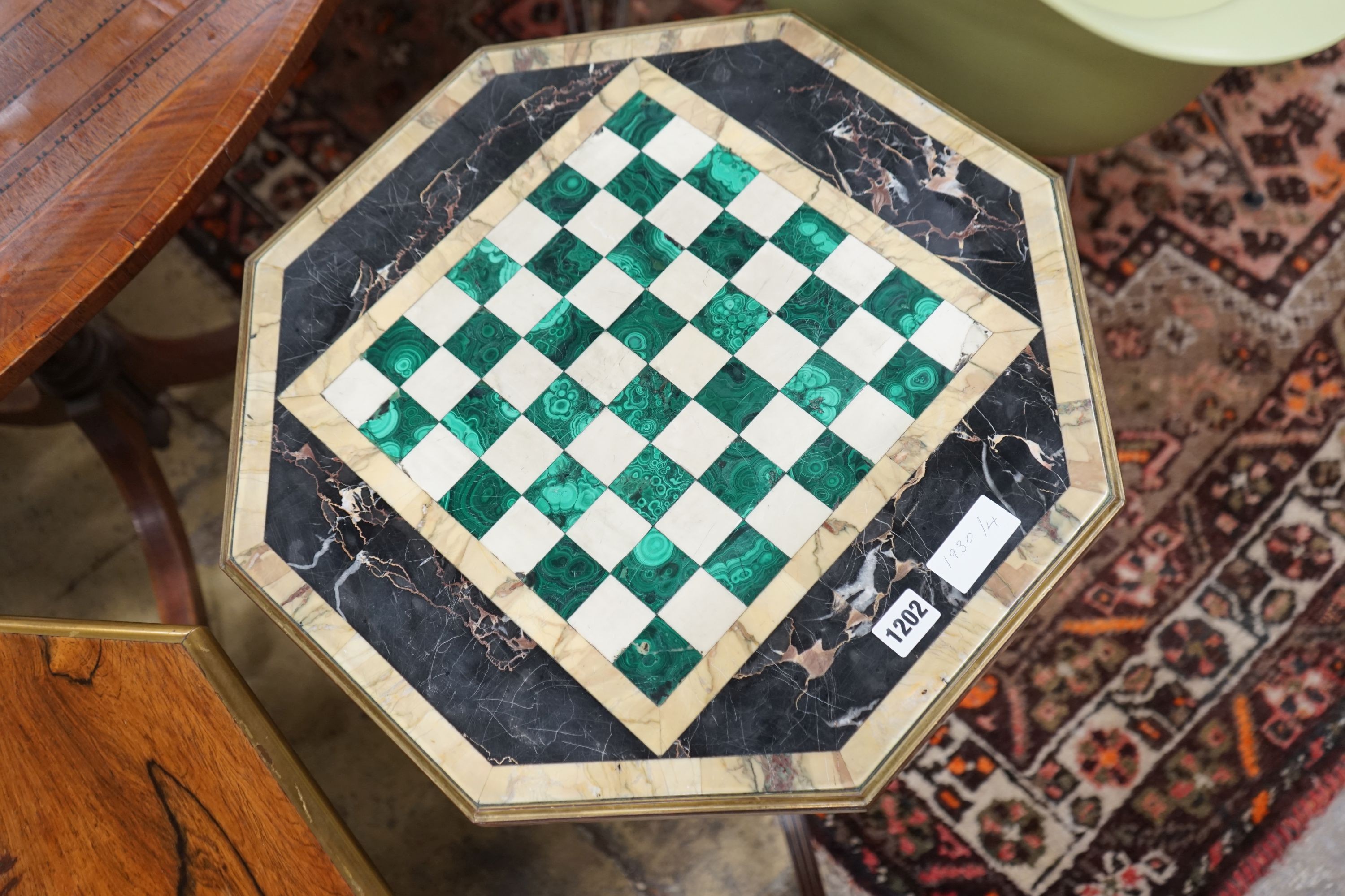 A Regency style brass mounted octagonal rosewood and specimen marble games table, width 49cm, height 70cm